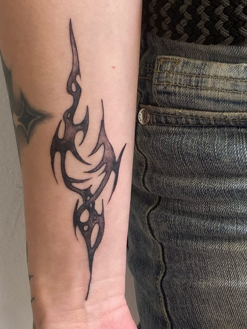 Neo-tribal flame down the forearm, healed