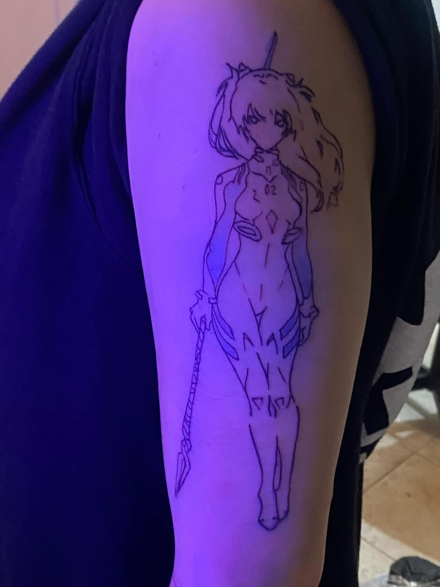 Evangelion pilot outline on the upper arm under violet light