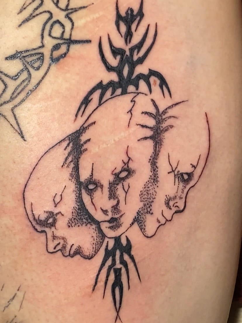 Three dotwork faces with tribal spine, wider view
