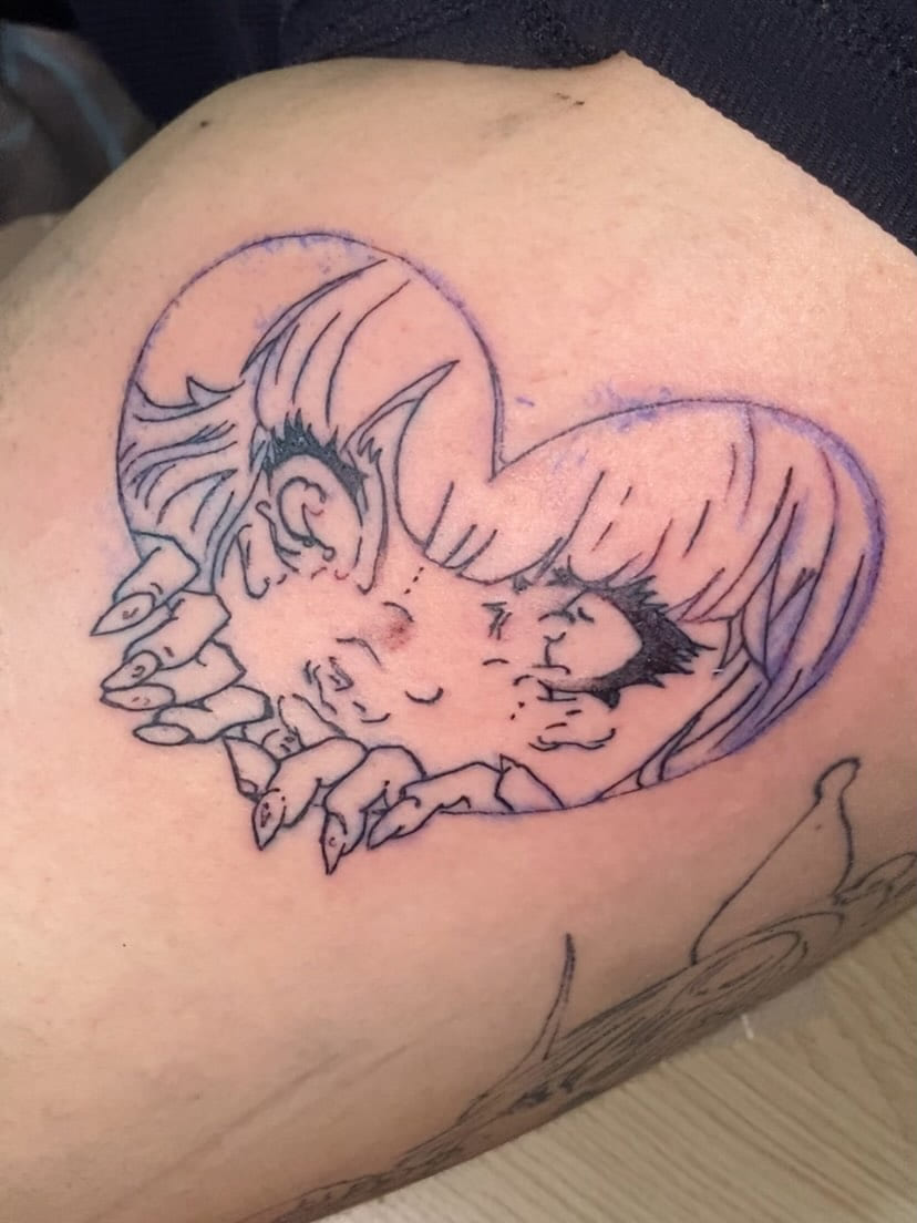 Heart with two anime figures and clawed hands, close view