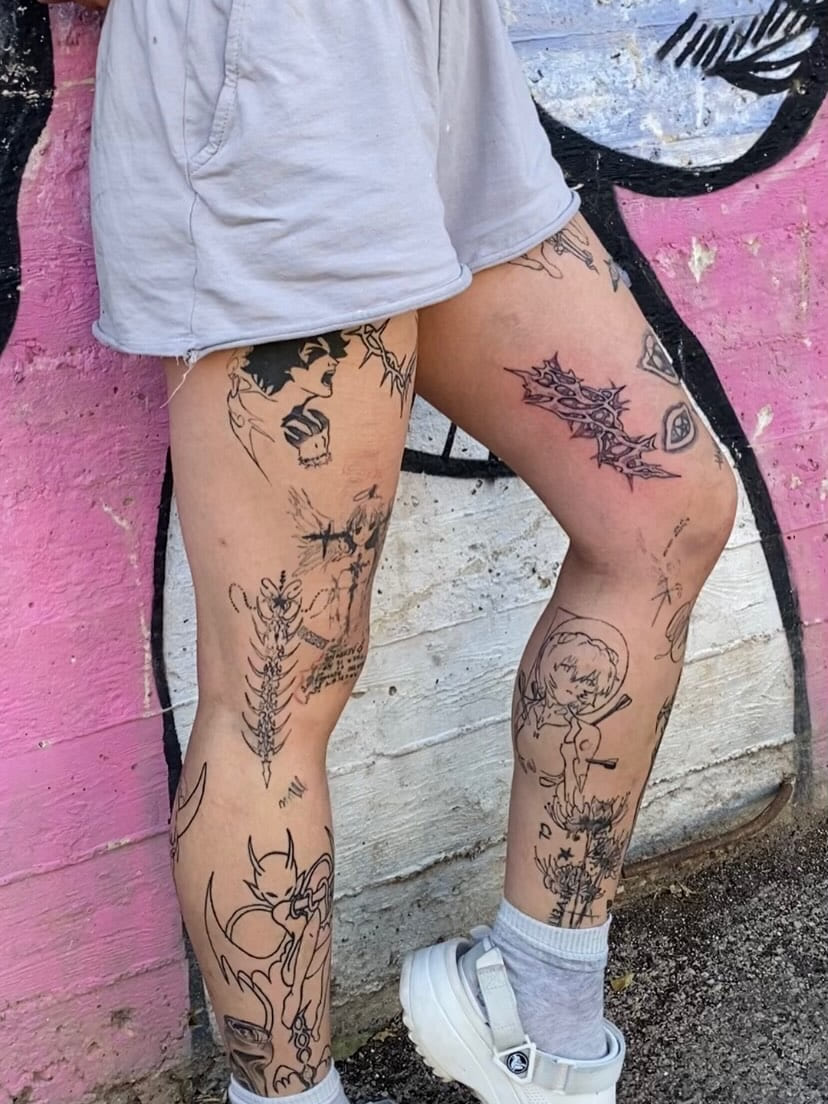 Both legs carrying an accumulated collection of blackwork pieces, healed