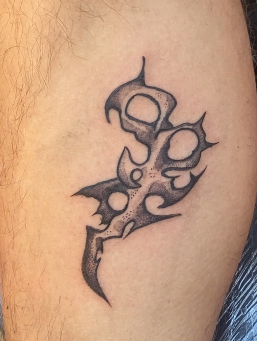 Perforated bone sigil on the thigh, healed, daylight