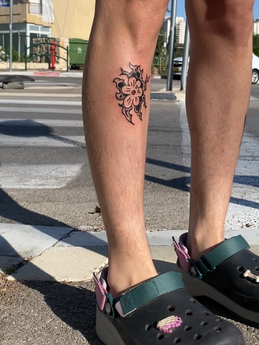 Flower with tribal blades on the calf, street view