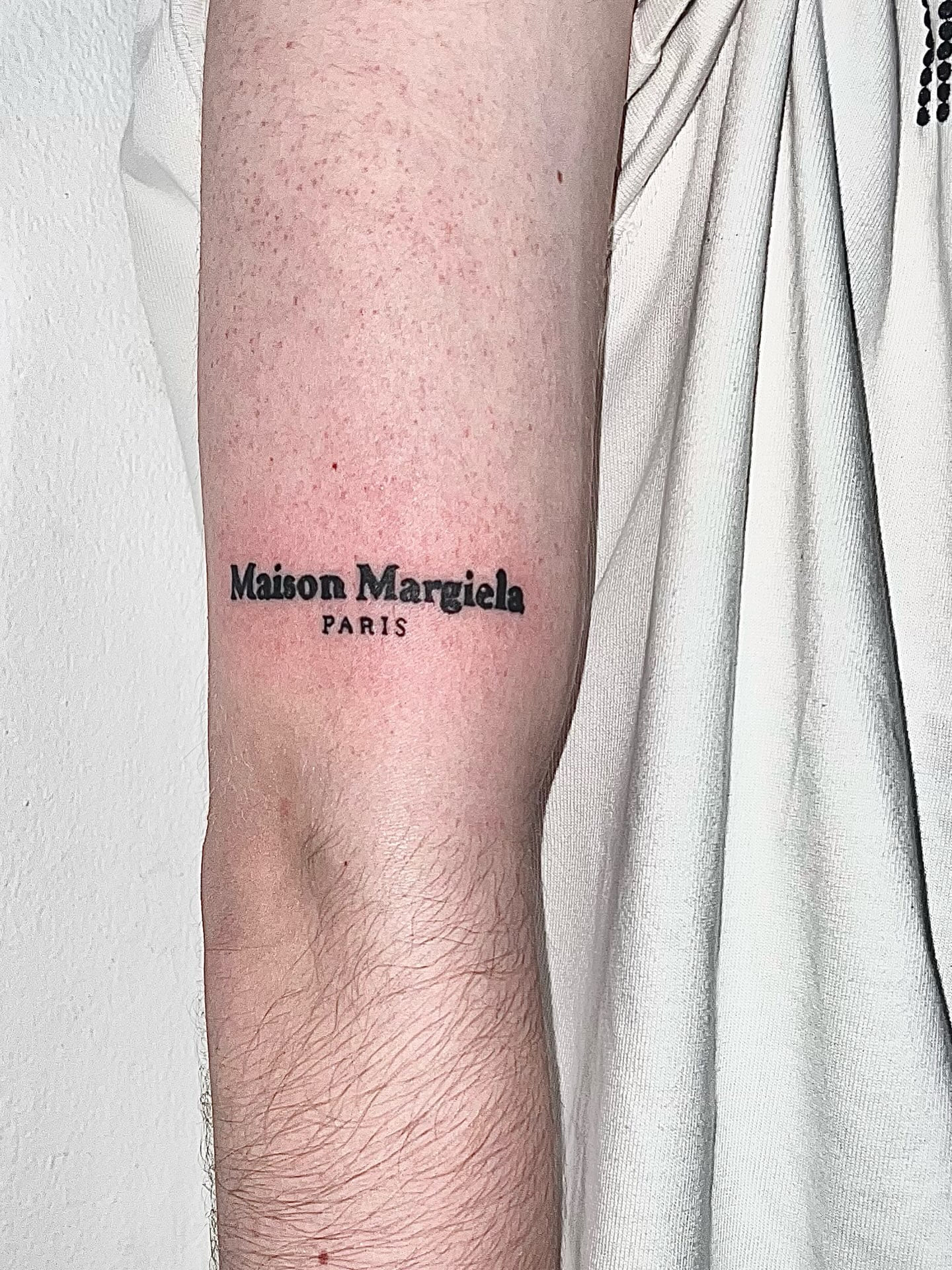 Maison Margiela micro-lettering on the forearm
